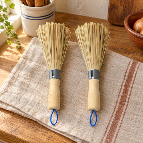 Kindred Bamboo Brush Pair hero: Two Kindred wooden-handled brushes with pale bristles and blue cord loops