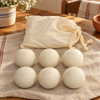 Meadow Wool Dryer Ball Set hero: Six Meadow cream wool balls and one cotton bag