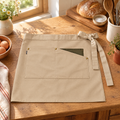 Pantry Pocket Half Apron hero: Pantry’s complete short beige pocket apron