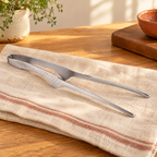 Pass Stainless Serving Tong hero: Complete silver Pass serving tong with folded spring bow and two narrow tips