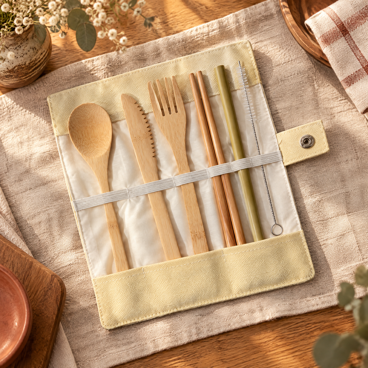 Pocket Bamboo Cutlery Set hero: Pocket beige canvas roll open with seven bamboo and brush implements