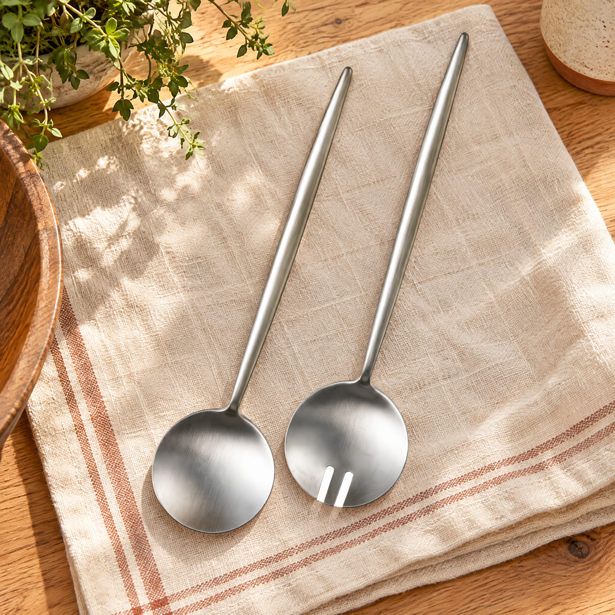 Salad Stainless Serving Pair detail: The solid spoon and two-slotted fork heads of the complete Salad pair