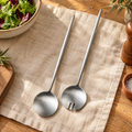 Salad Stainless Serving Pair hero: Two complete silver Salad servers with round spoon and slotted fork heads