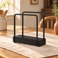 Welcome Napkin Holder hero: Complete black Welcome napkin holder with two open rounded-rectangle sides and a low rectangular base