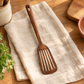 Willow Wooden Slotted Turner hero: Willow wooden slotted turner on oat linen