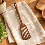 Willow Wooden Slotted Turner hero: Willow wooden slotted turner on oat linen