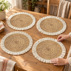 Woven Straw Placemat Set use: One hand straightening one mat while the other three remain visible